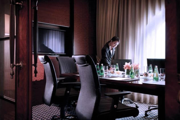 Image of a person setting up a boardroom