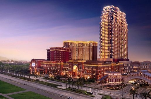 The Sands hotel lit up at dusk