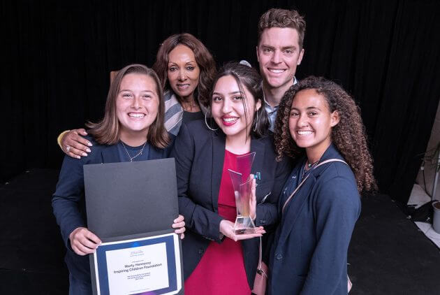 A group of five people posing for a photo