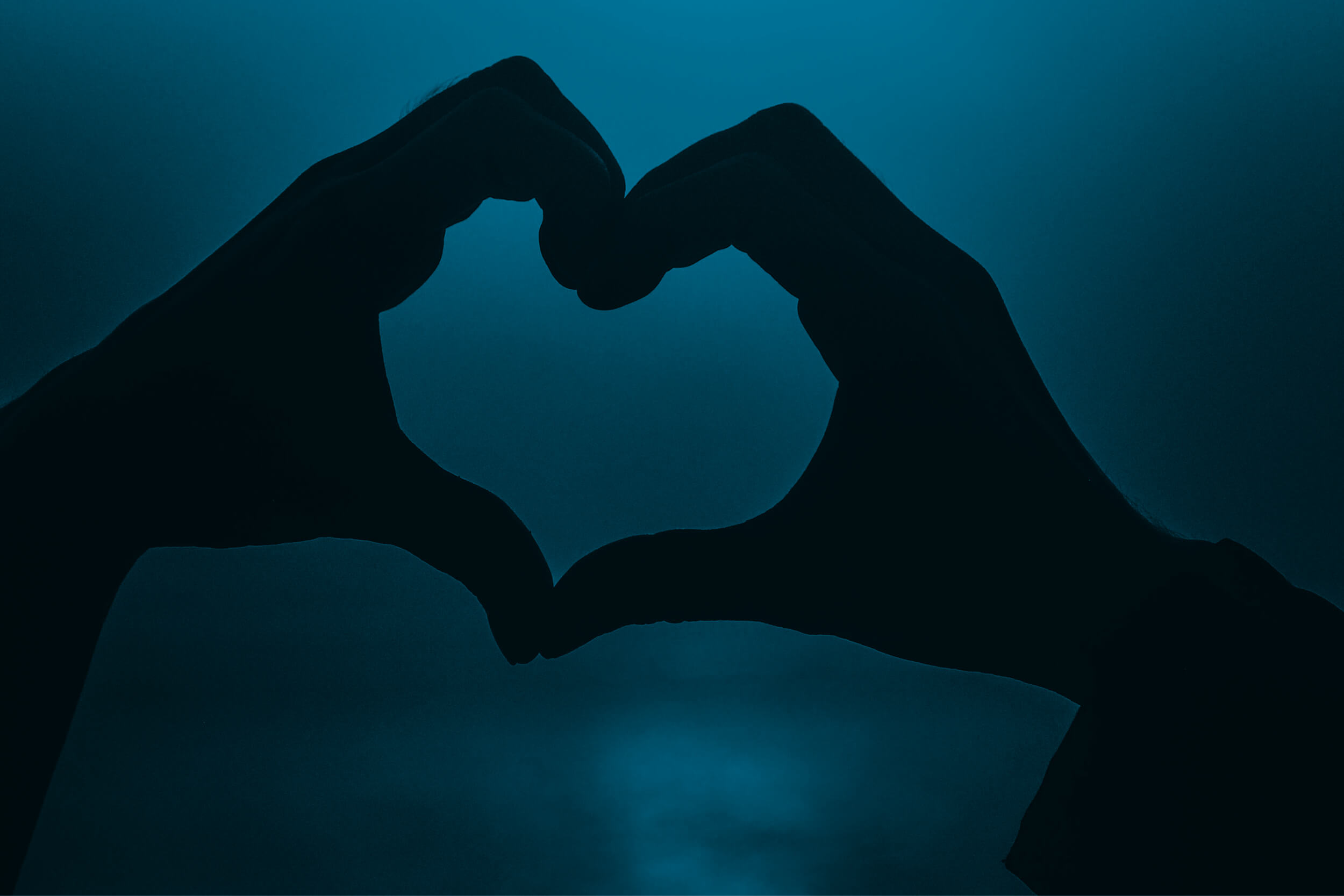 An image of two hands touching to create a heart