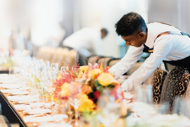 Image of a man arranging a table setting