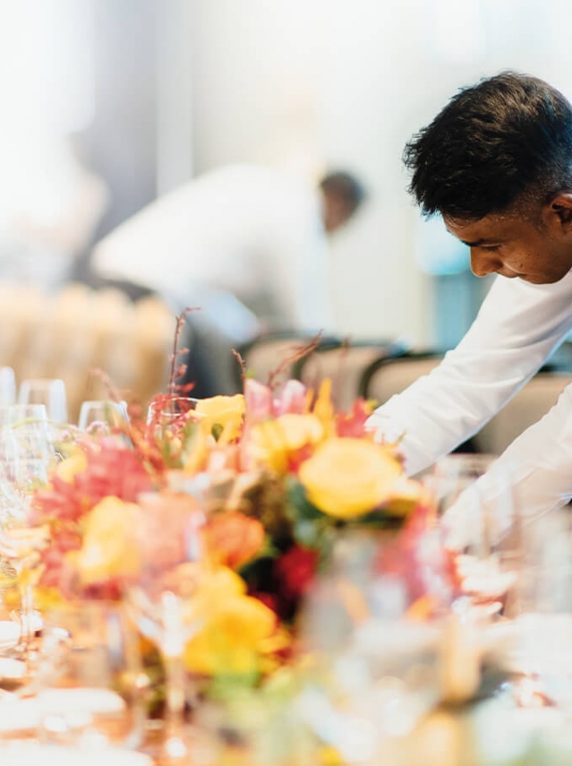 Image of a man arranging a table setting