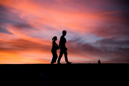 A couple walking at sunset