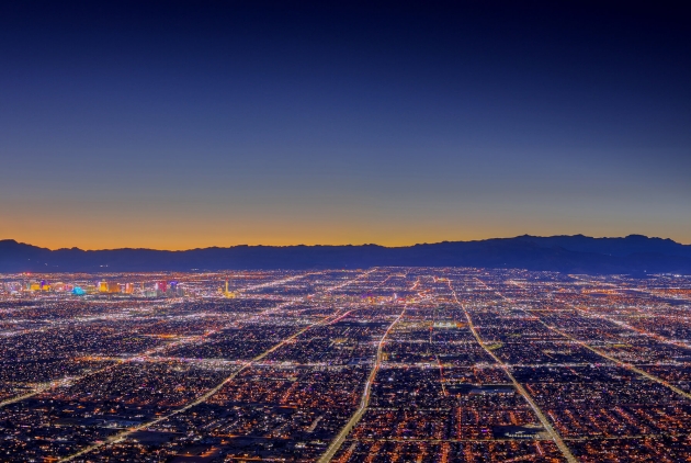 A wide shot of the Las Vegas skyline at sunset with the mountains in the background