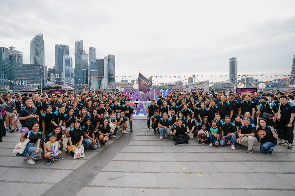 large group of volunteers on the waterfront in singapore
