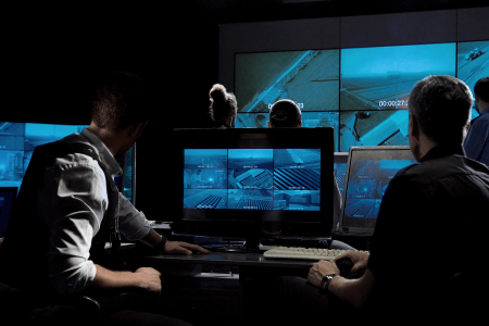a surveillance team reviewing screens